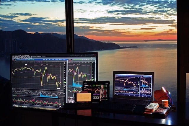 Trading Monitors Overlooking a Sunset